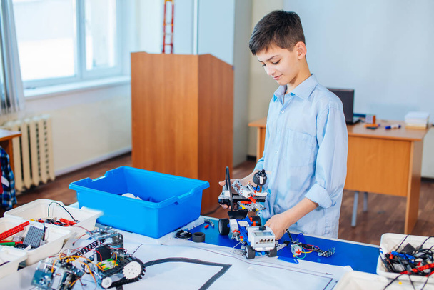 Little boy in robotics school makes robot - Fotó, kép