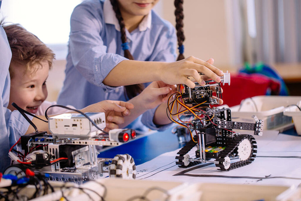 Two children, brother with sister enaging in their hobby-constructing robot toys - 写真・画像