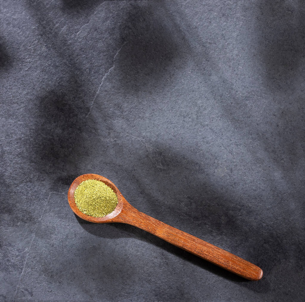 Organic green powder on wooden spoon - text space - Photo, Image