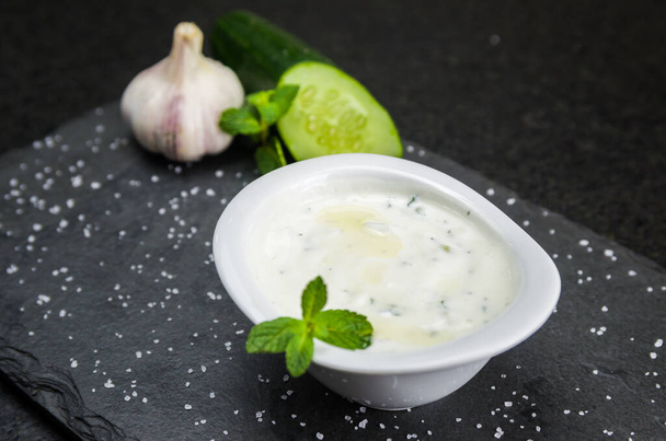 Delicious Lebanese (Arabic) food, Tzatziki sauce, produced with garlic, cucumber, mint and labneh. - Fotoğraf, Görsel