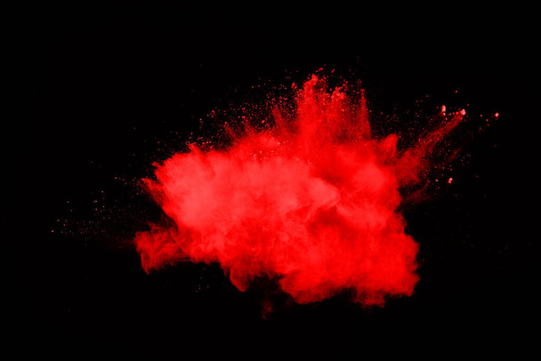 elvont vörös por robbanás fekete hátterben.elvont vörös por fröccsent fekete háttér. A vörös por felrobbanásának fagyott mozgása. - Fotó, kép
