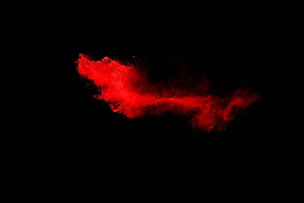 abstract red powder explosion on black background.abstract red powder splatted on black background. Freeze motion of red powder exploding. - Fotó, kép