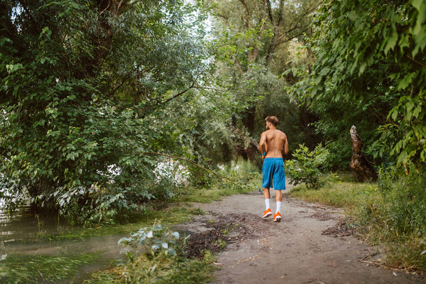 Sport running fitness man with bare-chested training  in forest - Foto, Imagem