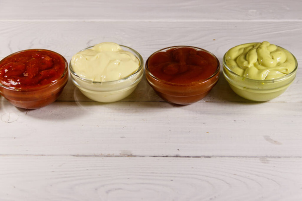 Set of sauces on white wooden table - Photo, Image