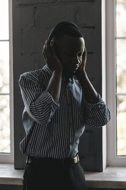 african-american man in stylish shirt in headphones listening music and enjoying music, dancing  - Φωτογραφία, εικόνα