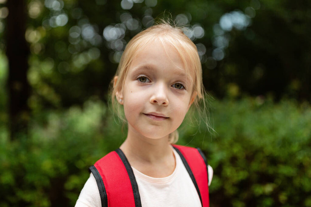 School child after end coronavirus pandemic outbreak. Blonde girl going back to school after covid-19 quarantine and lockdown. Happy kid outdoor. New normal. High quality photo - Fotografie, Obrázek