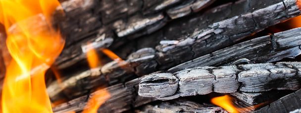 Flammen aus Feuer und glühende Kohlen aus verbranntem Holz. Raum für Kopie, Text, Ihre Worte. - Foto, Bild