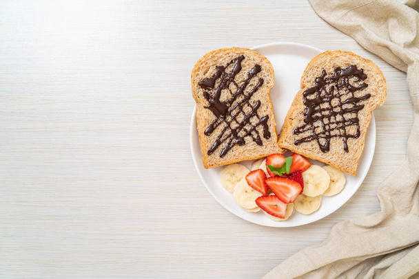 whole wheat bread toasted with fresh banana, strawberry and chocolate for breakfast - Фото, зображення