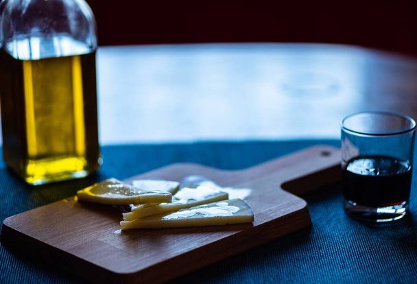 A closeup shot of triangular doughs on the cutting board next to oils - Фото, зображення