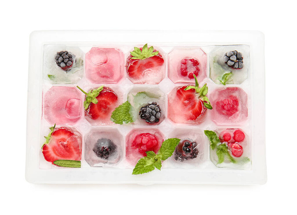 Tray with berries in ice on white background - Foto, immagini