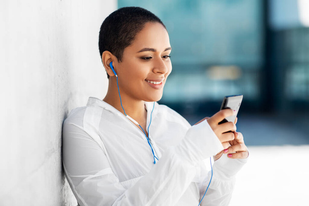 african american woman with earphones and phone - Foto, Imagen