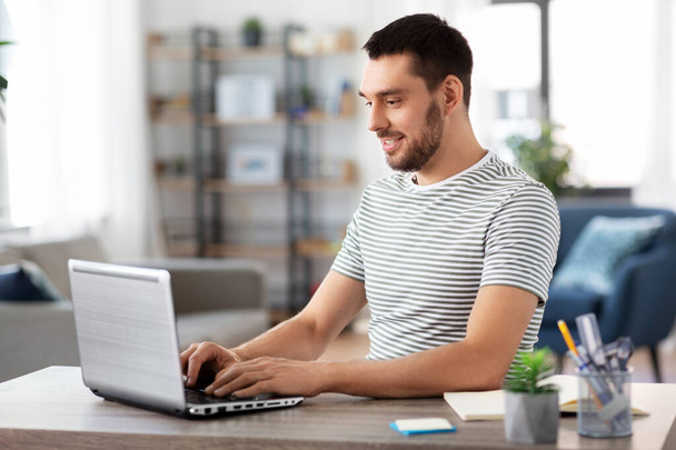 man with laptop working at home office - Photo, Image