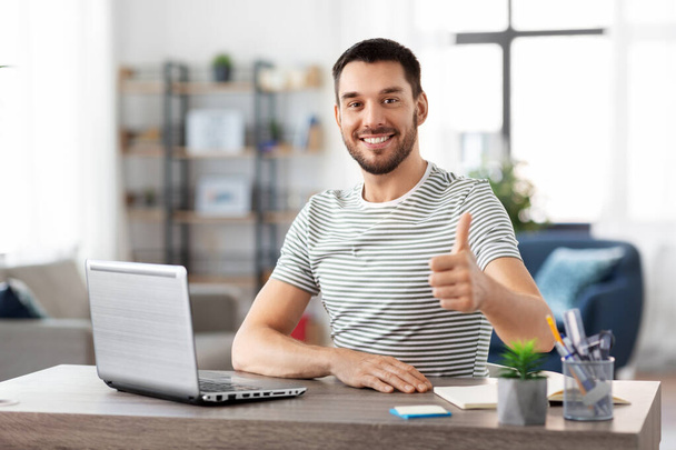 happy man with laptop working at home office - Foto, Imagem