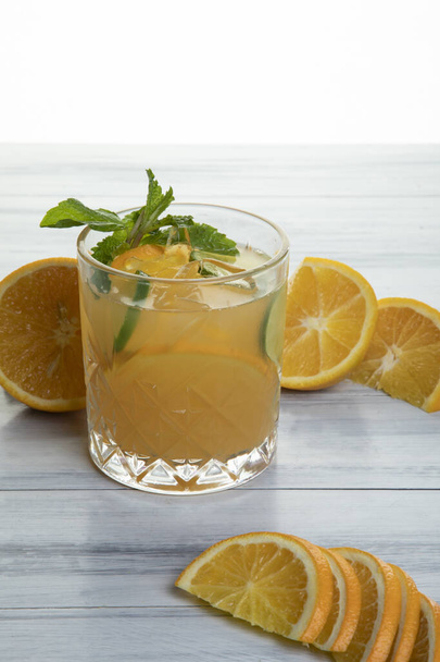 Orange Mojito made with white rum, mint leaves, orange and lime wedges topped with soda - Photo, Image