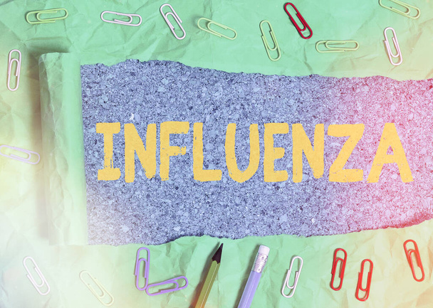 Text sign showing Influenza. Conceptual photo any of various respiratory infections of undetermined cause Rolled ripped torn cardboard placed above a wooden classic table backdrop. - Photo, Image