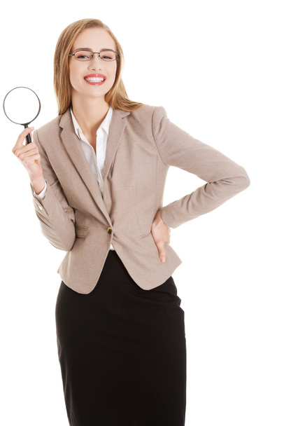 Beautiful caucasian business woman with magnifying glass. - Foto, afbeelding