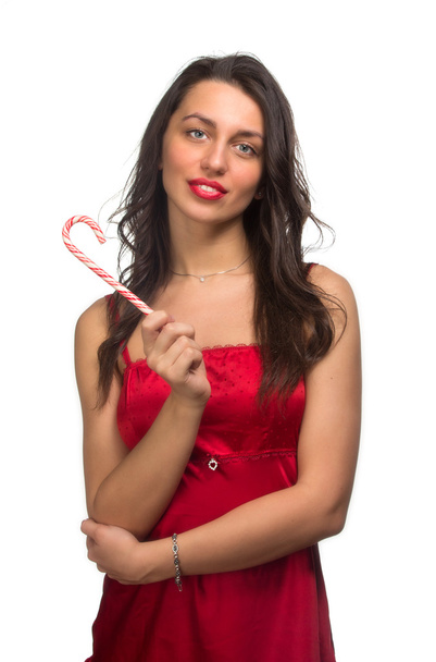 girl lick white-red candy in the form of heart with beautiful ma - Φωτογραφία, εικόνα