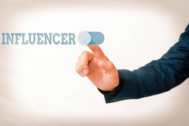 Writing note showing Influencer. Business photo showcasing the an individual who inspires or guides the actions of others Model with pointing hand finger symbolizing navigation progress growth. - Photo, Image