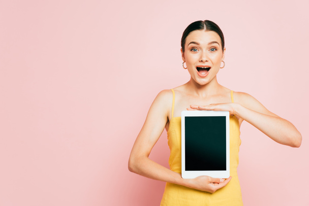 excited brunette young woman holding digital tablet with blank screen on pink - Fotografie, Obrázek