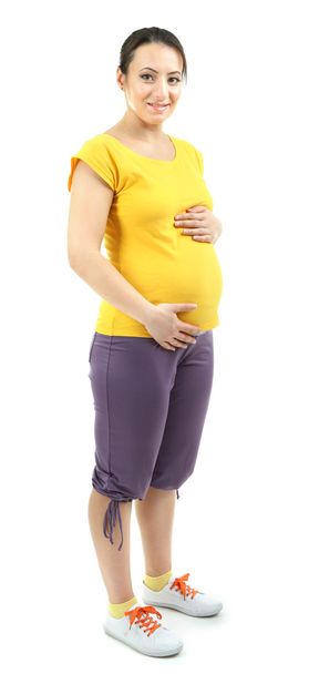 Beautiful young pregnant woman touching her belly isolated on white - Foto, Bild
