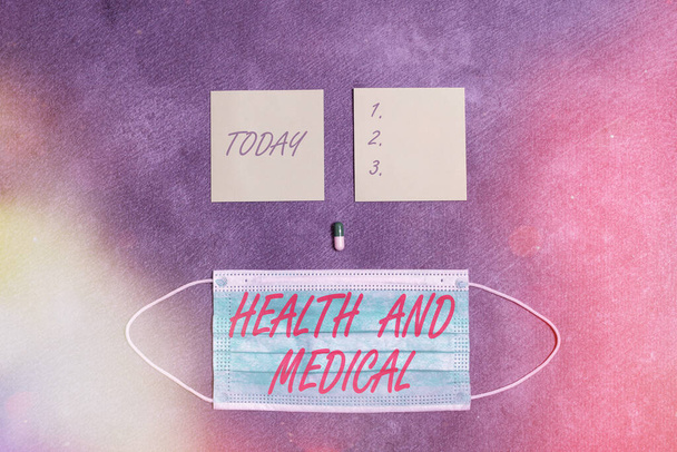 Text sign showing Health And Medical. Conceptual photo study and investigation of physical and mental wellbeing Set of medical equipment with notepad for professional health condition assessment. - Photo, Image