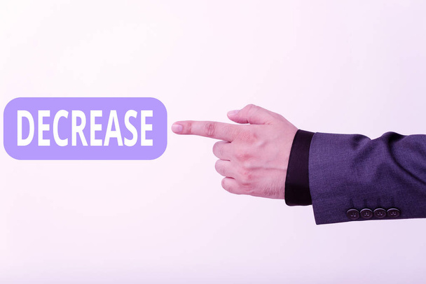 Text sign showing Decrease. Conceptual photo the process of growing progressively less in size, amount, etc. Model with pointing hand finger symbolizing navigation progress growth. - Photo, Image