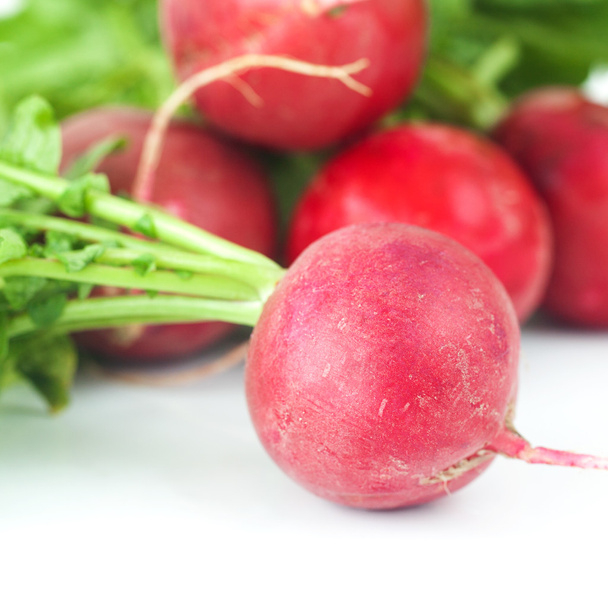 juicy red radishes with green leaves isolated on white - Fotografie, Obrázek