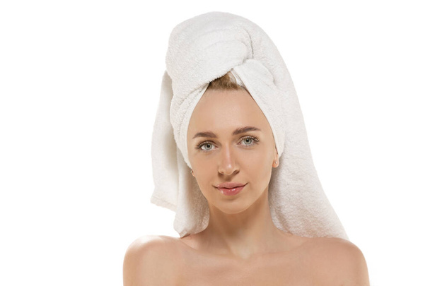 Beauty Day. Woman wearing towel doing her daily skincare routine. Portrait isolated on white studio background - Zdjęcie, obraz
