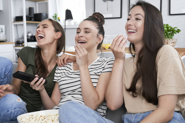 Best friends watching comedy movie at home - Фото, зображення
