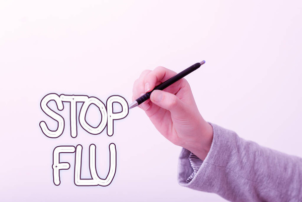 Text sign showing Stop Flu. Conceptual photo put an end of the viral infection of your lungs and airways Model displaying different shots of holding pen ready for promotional use. - Photo, Image