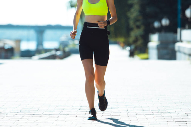 Female runner, athlete training outdoors in summers sunny day. - Фото, изображение