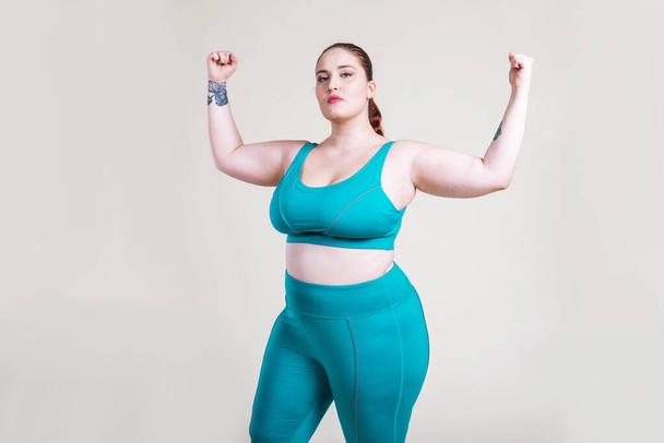 Plus size women making sport and fitness. Studio portraits with multiethnic curvy girls - Фото, изображение