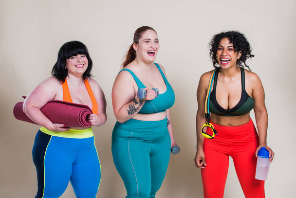 Plus size women making sport and fitness. Studio portraits with multiethnic curvy girls - Fotó, kép
