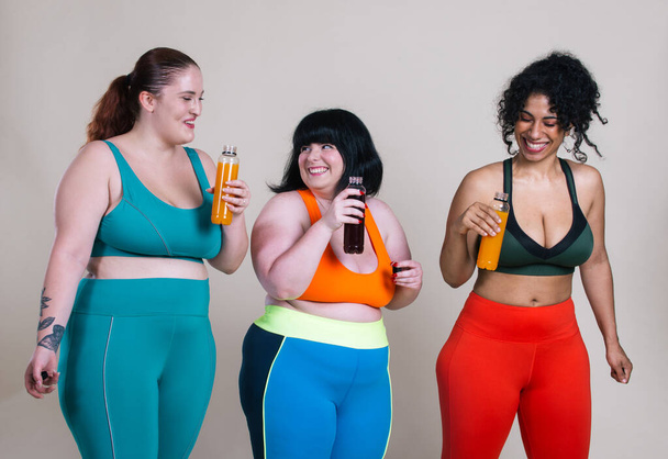 Plus size women making sport and fitness. Studio portraits with multiethnic curvy girls - Photo, Image