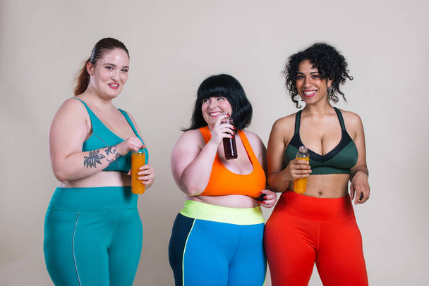 Plus size women making sport and fitness. Studio portraits with multiethnic curvy girls - Photo, Image