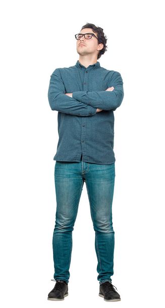 Full length portrait of confident businessman posing with arms crossed isolated over white background. Serious and focused facial expression looking away. Convinced business person wears eyeglasses. - Photo, Image