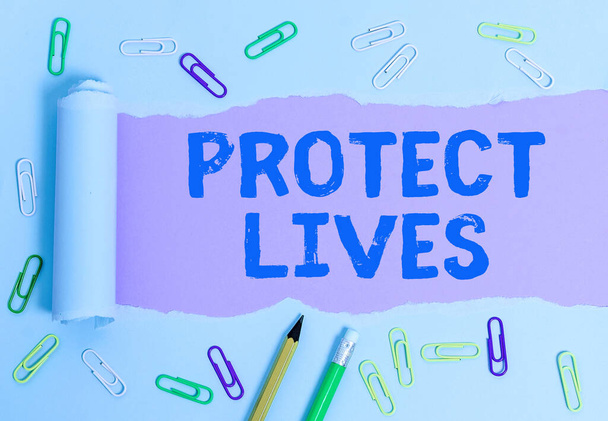 Text sign showing Protect Lives. Conceptual photo to cover or shield from exposure injury damage or destruction Rolled ripped torn cardboard placed above a wooden classic table backdrop. - Photo, Image