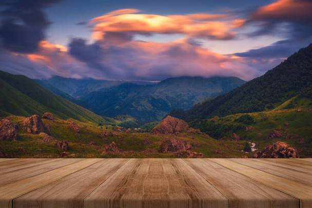 Summer beautiful background with sunrise over mountains and empty wooden table in nature outdoor. Natural template landscape. - Photo, Image