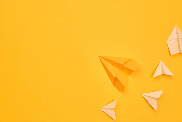 Minimalismus gelbe Papierflieger auf gelbem Hintergrund. Reise, Flug, Ebene, Kopierraum eins - Foto, Bild