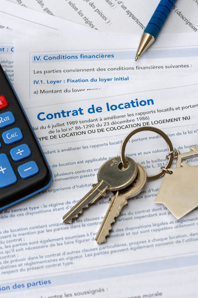 Real estate: french housing rental contract (empty rental lease). Close-up with a bunch of keys, a pen and a calculator. France - Photo, Image