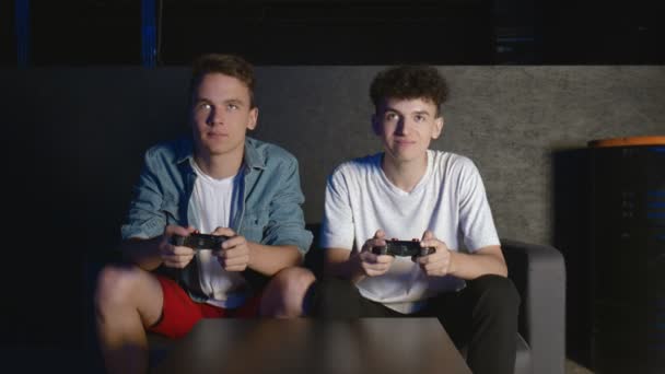 Two gamers in front of the screen are playing together in the online battle - Footage, Video