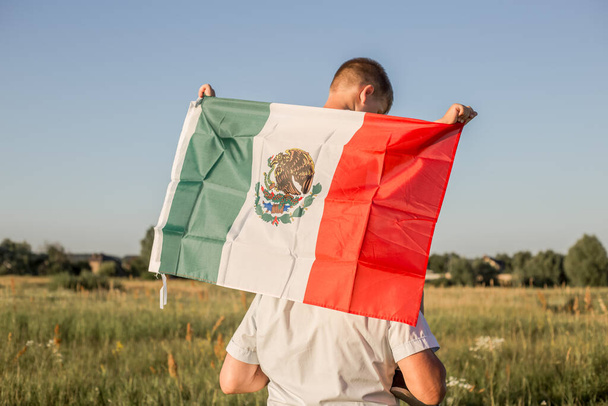 Junge mit mexikanischer Fahne. "16. September. Unabhängigkeitstag Mexikos. Mexikanischer Unabhängigkeitskrieg, 1810." - Foto, Bild