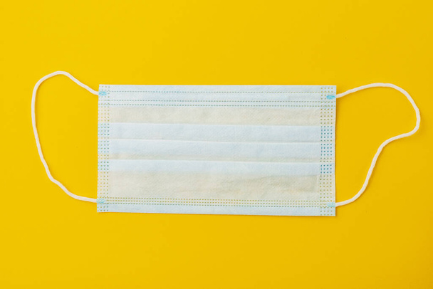 Classic surgical medical mask on paper background with copy space. - Foto, immagini