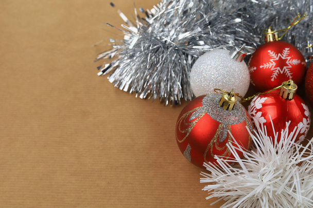 Christmas balls lies on craft paper with copyspace. Abstract Christmas background, selective focus. - Фото, изображение