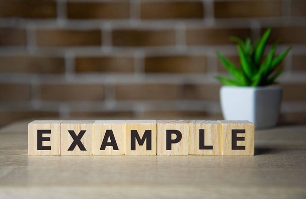 Concept word 'example' on wooden cubes on a beautiful background. Wooden table. Copy space. Business concept - Fotoğraf, Görsel