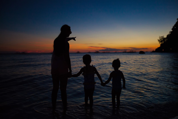 Family of three silhouette in the sunset on Boracay beach - Photo, Image