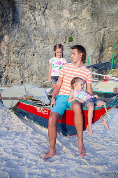 Young dad and his two little girls on a boat at the beach - Photo, Image