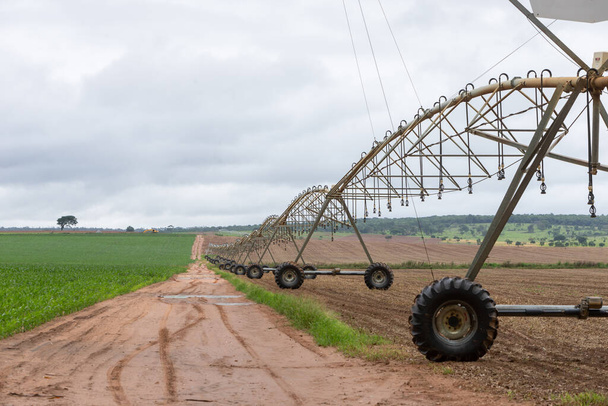 center pivot agricultural irrigation system watering on a farm field - Photo, Image