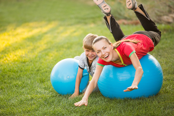 Mother and son having fun outdoors with sport gym ball - Fotografie, Obrázek