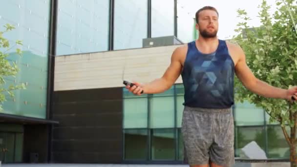 man exercising with jump-rope outdoors - Felvétel, videó